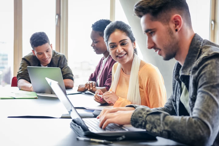 Students In Classroom At Desk