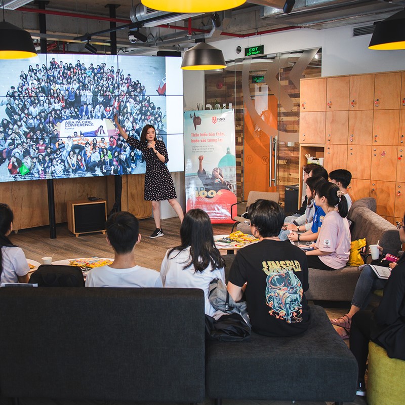 Lady doing a presentation with a big screen